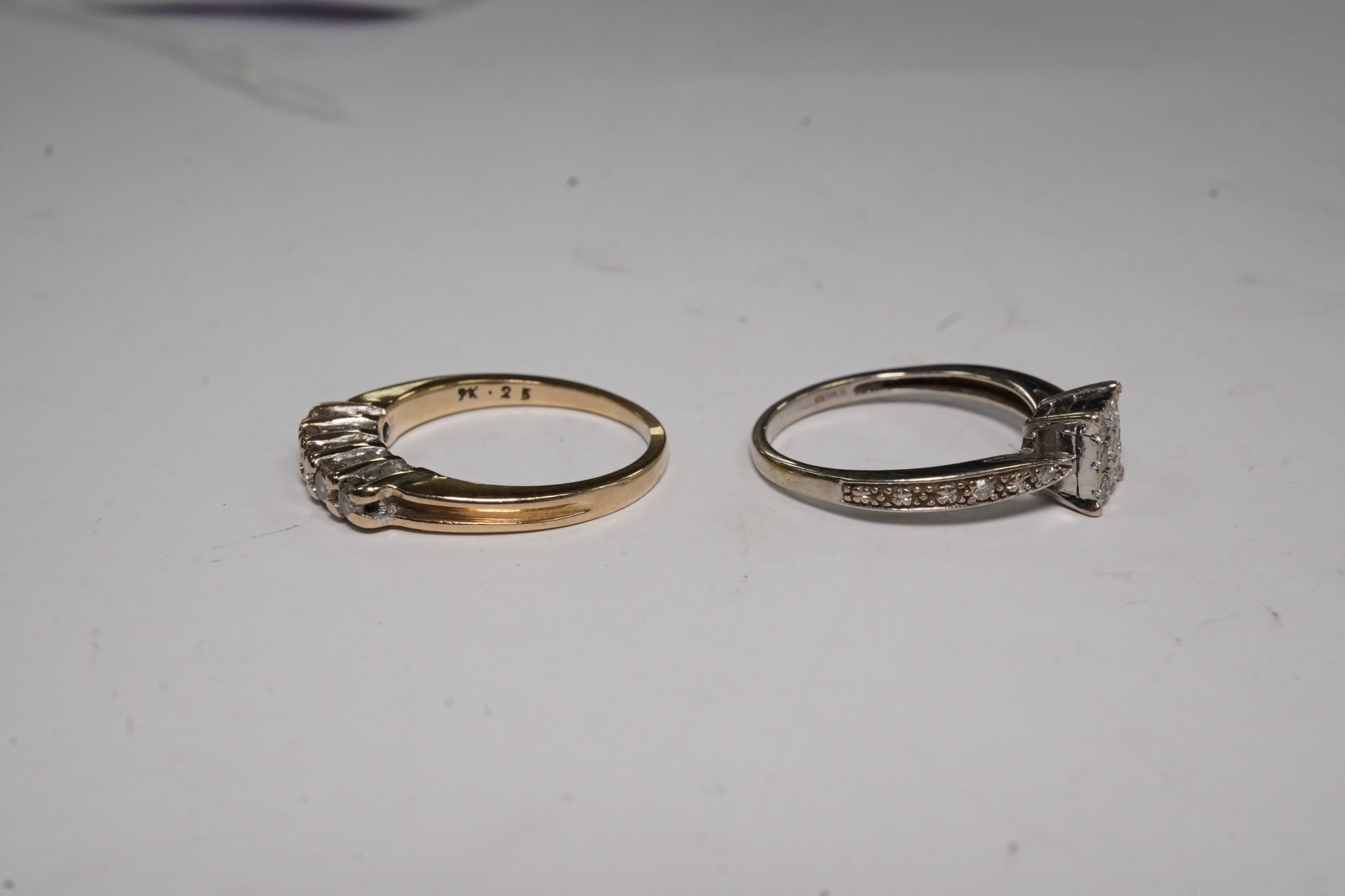 Two modern 9ct gold and diamond set rings, including square cluster and five stone half hoop, gross weight 4.2 grams.